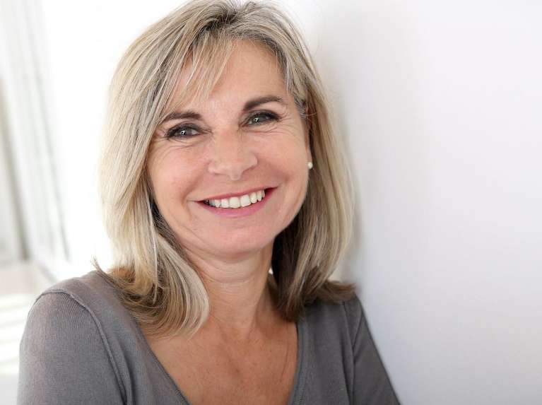 Lady smiling after getting dental crowns from Pradera Dental